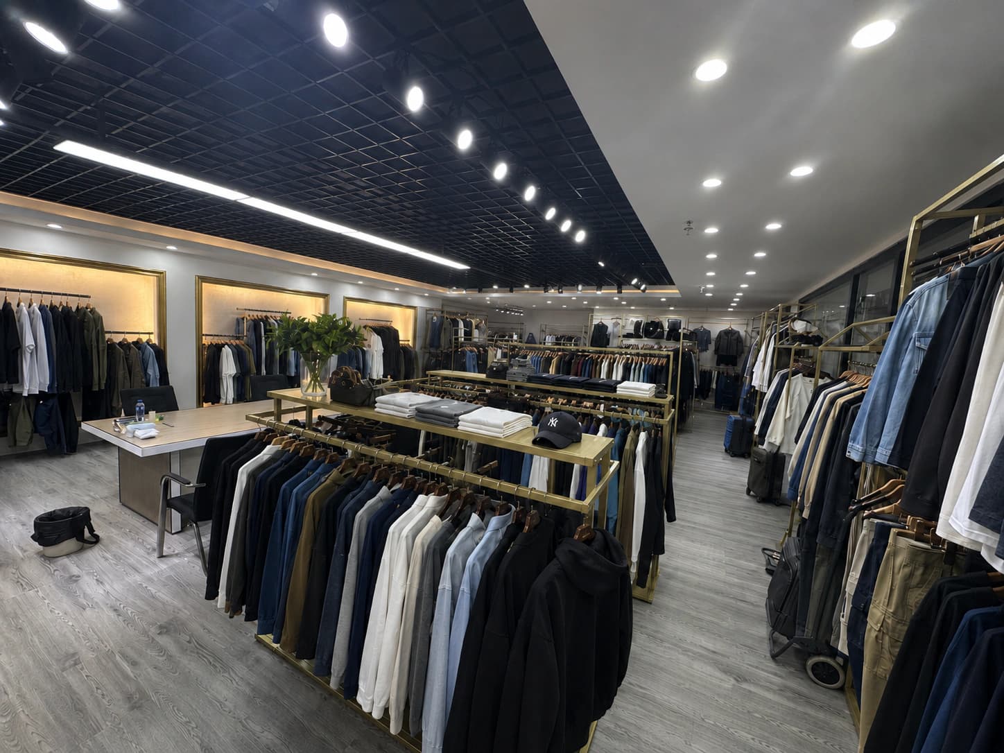 Kaouyou menswear sample showroom with custom T-shirts hoodies jackets and trousers